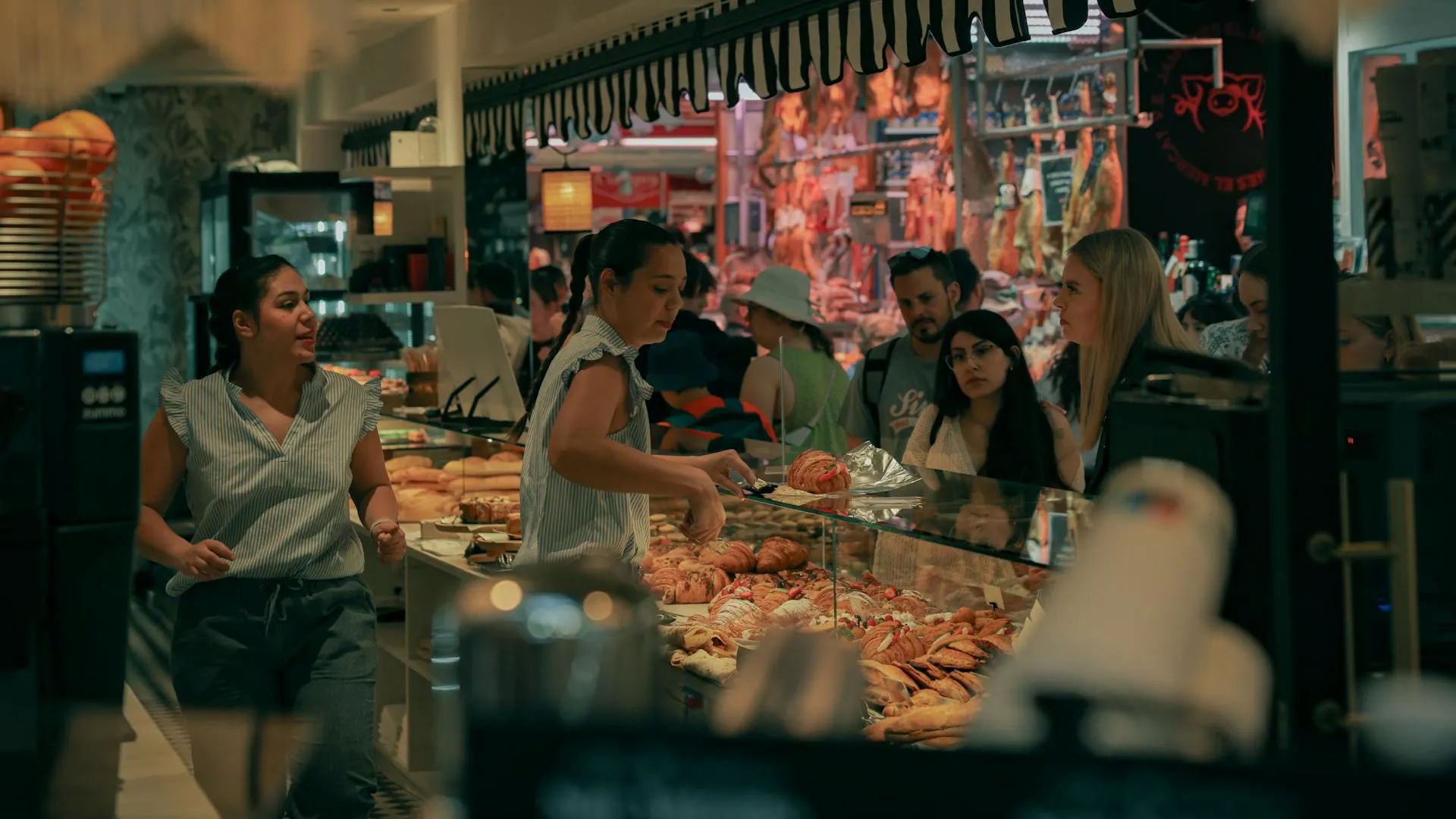 A group of people standing around a counter.