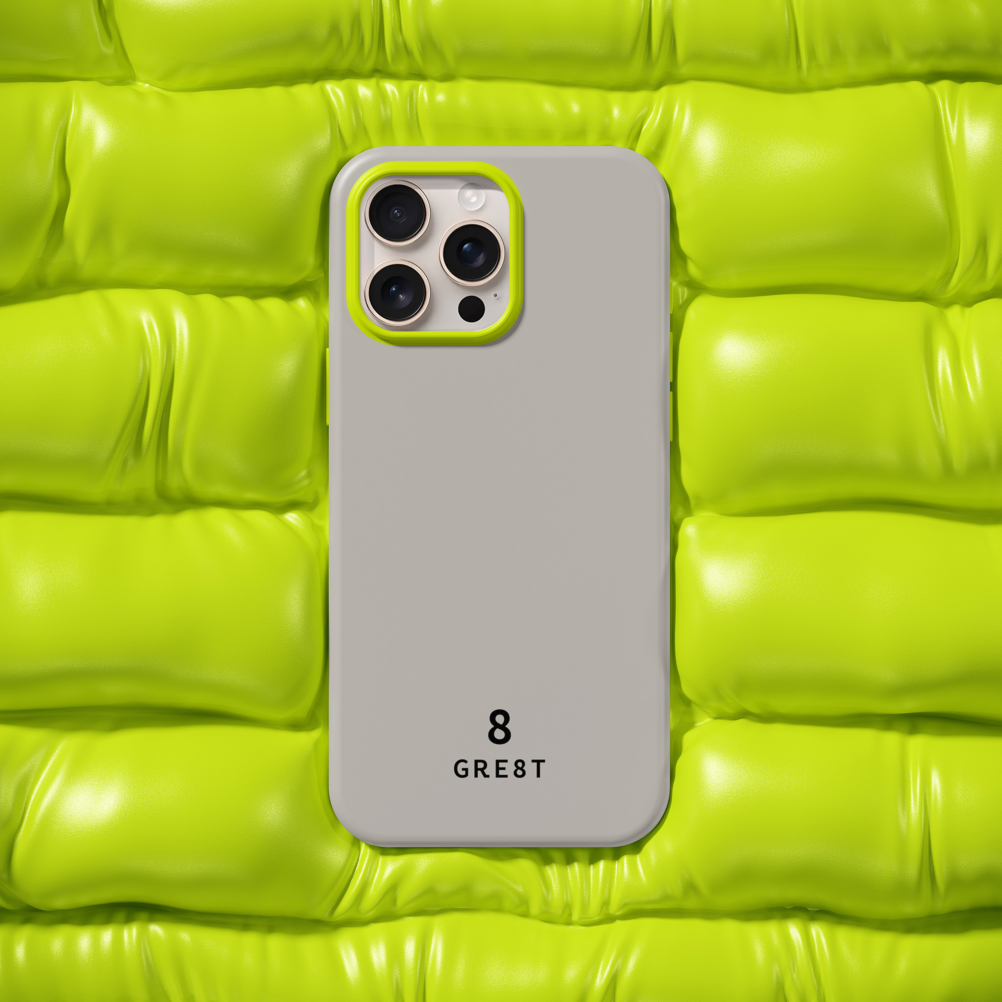 Smartphone with beige case and yellow-green camera border on a padded yellow-green surface.