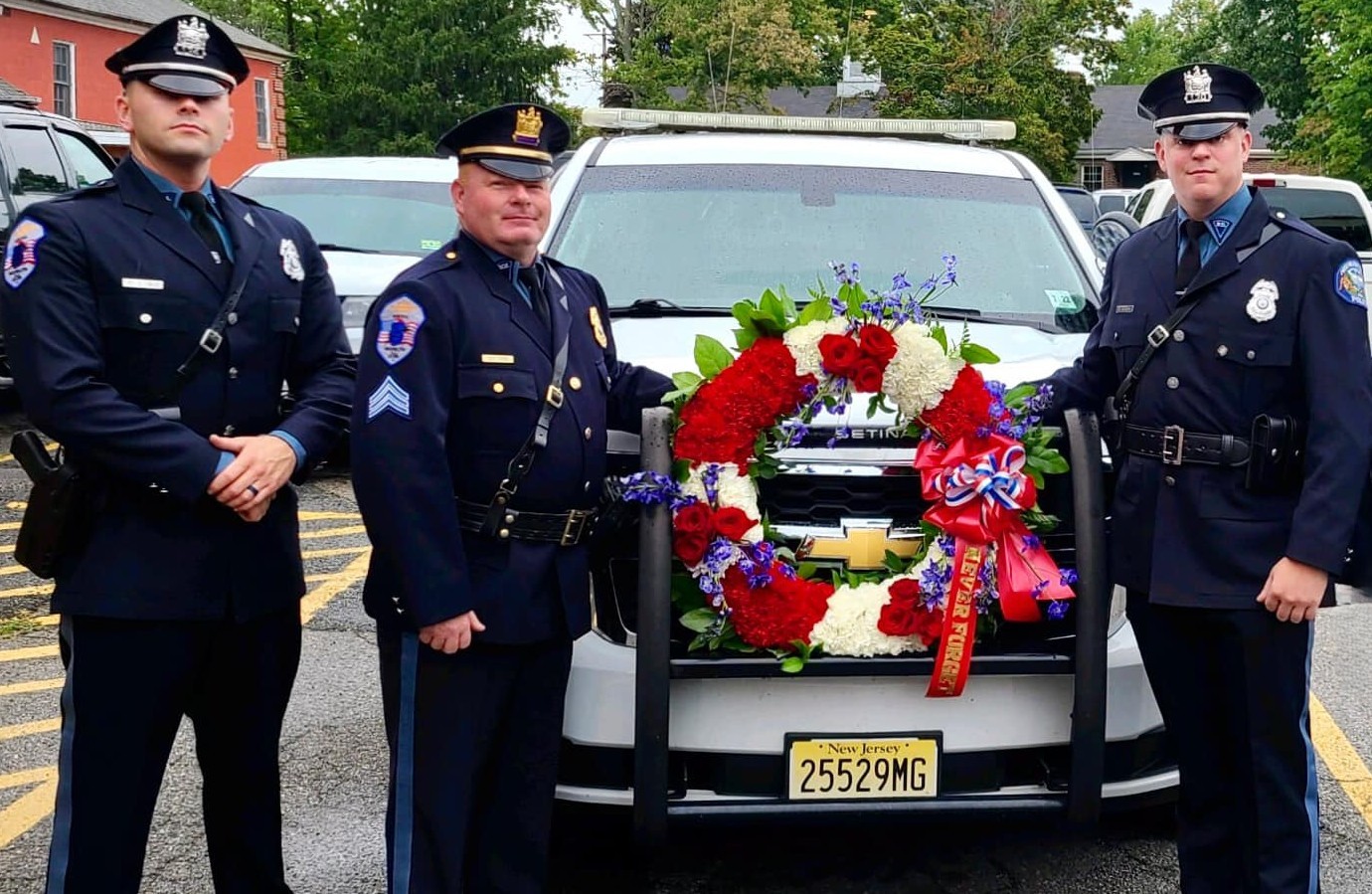Officers in Uniform standing next to the car
