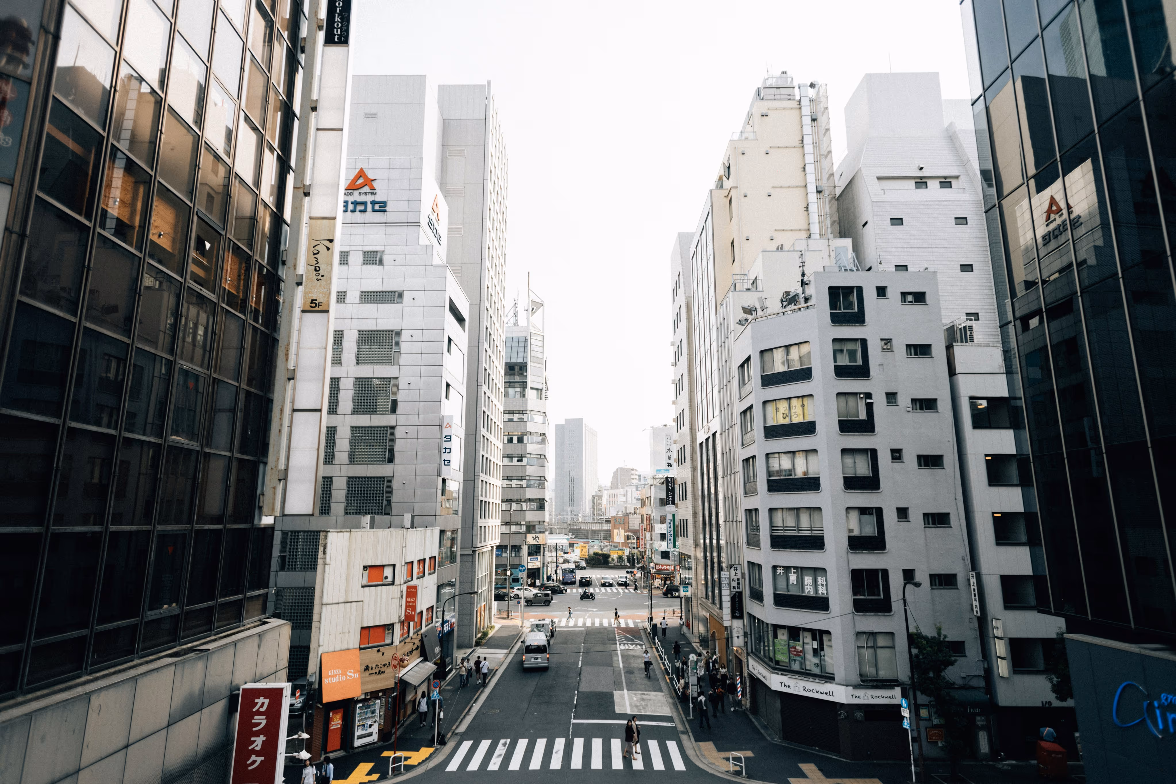 City street view between tall modern buildings.