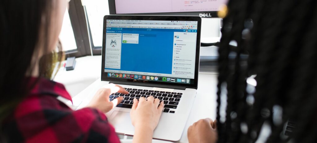 A photograph of two women looking at a laptop