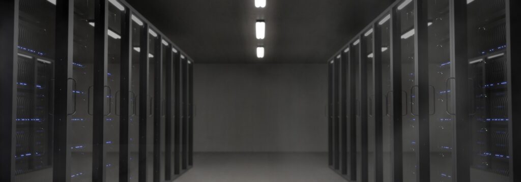 A photograph of a server room with several servers.