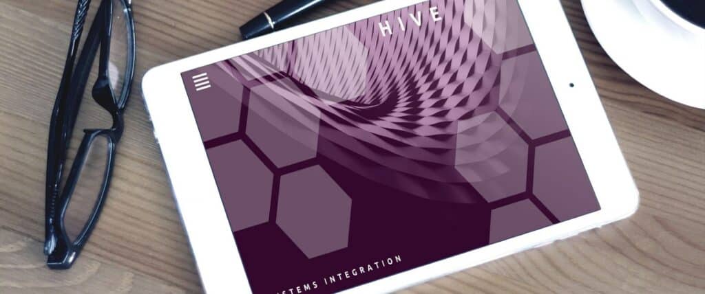 A photograph of a tablet next to a pair of reading glasses