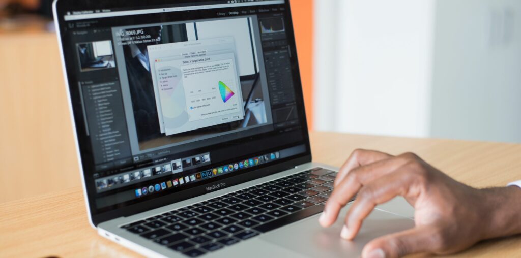 A photo of someone's hand using the touchpad mouse on a laptop.