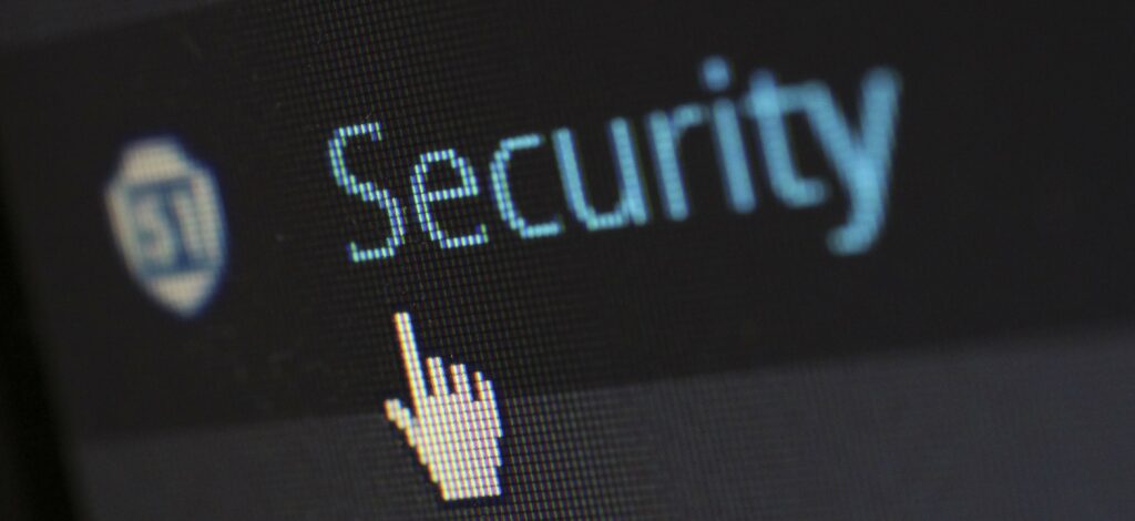 A photograph of a cursor on a computer screen hovering over the word, "Security."
