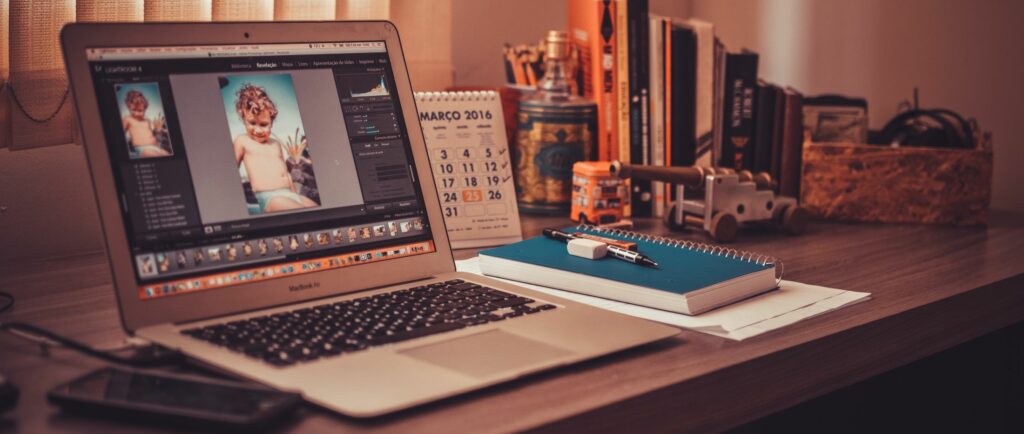 A photograph of a laptop in a home office