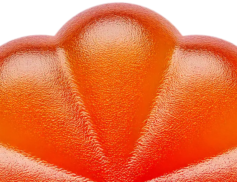 A close up of an orange substance on a black background.