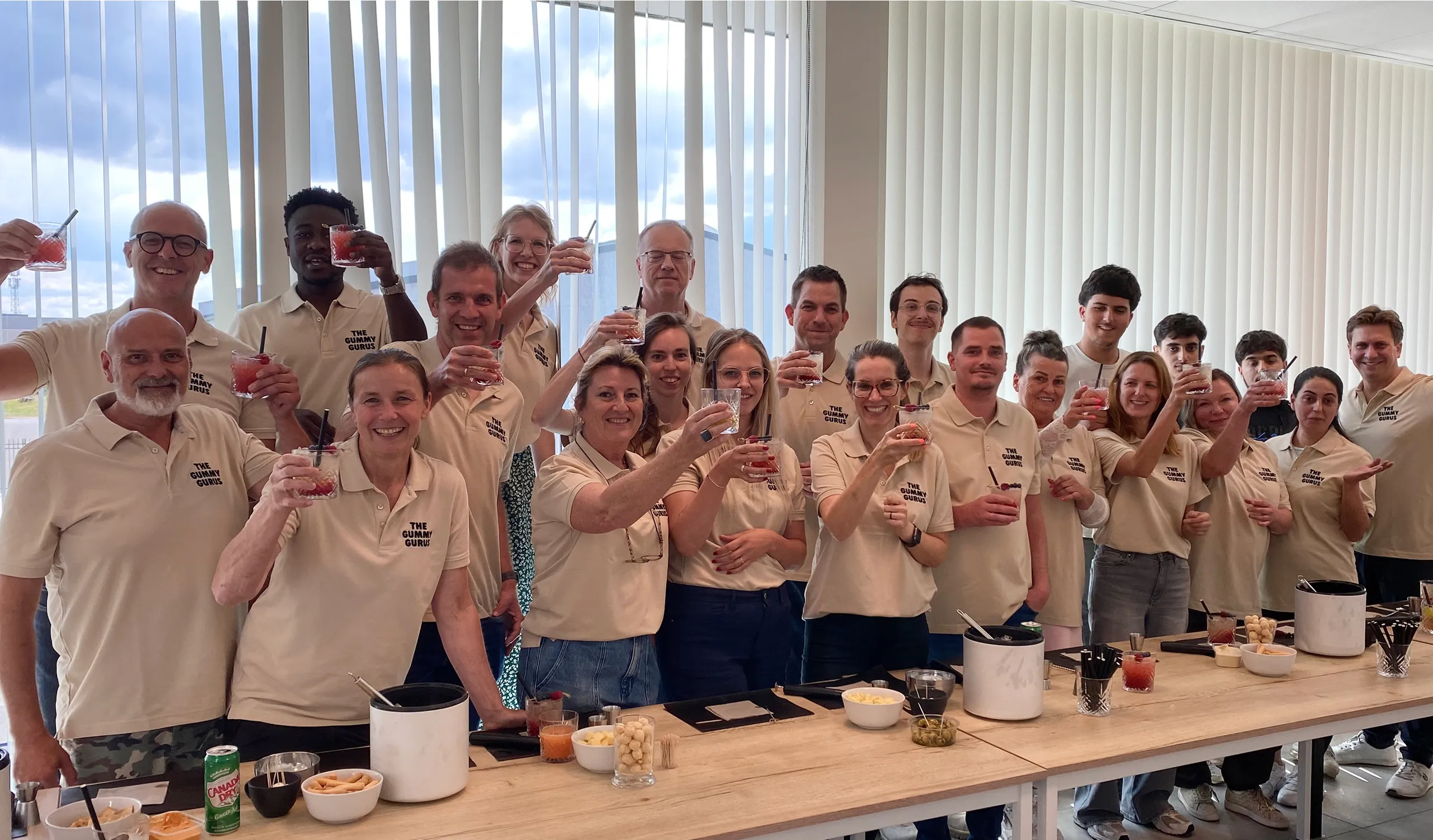 A group of people taking a picture with their cell phones.
