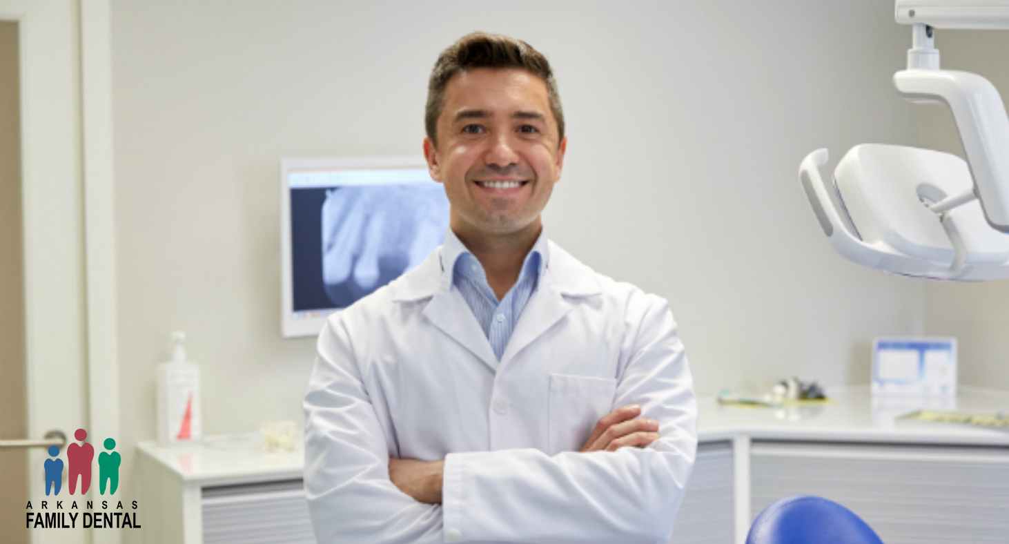 A male doctor specializing in Botox smiles with his arms crossed in a dental exam room.