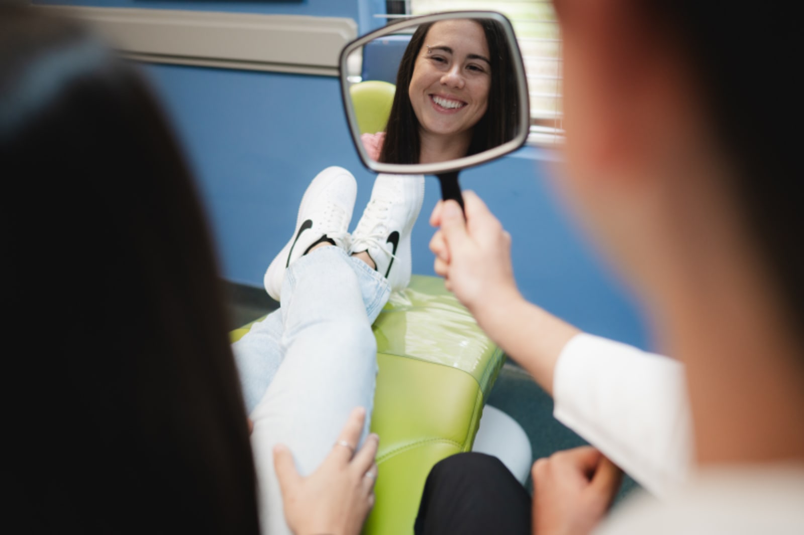 Dentist showing dental model to patient during consultation