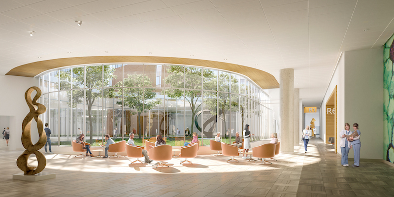 Bright modern interior with curved windows, trees, and people sitting in orange chairs