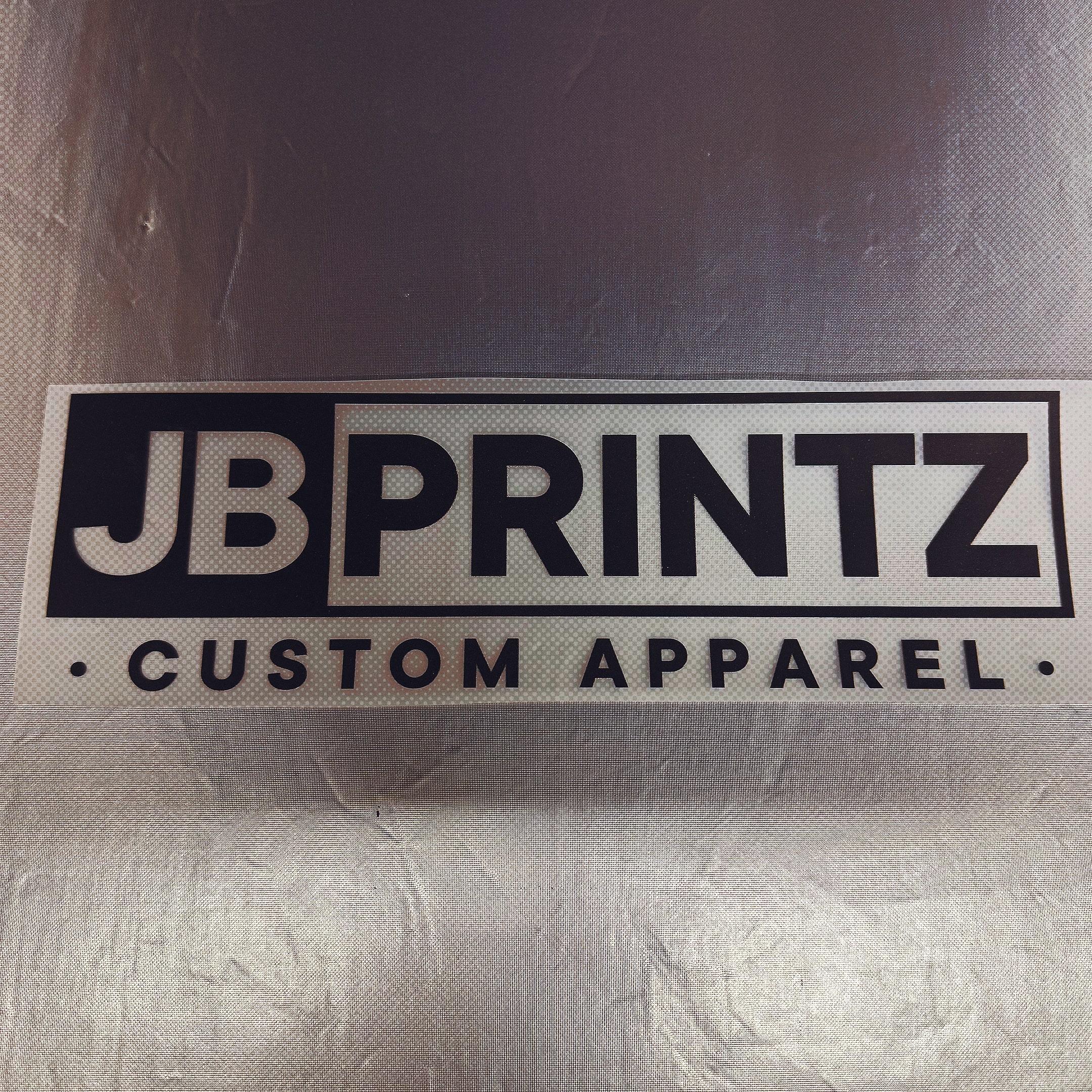 A print shop worker lays an image on a tshirt to be  DTF transfered