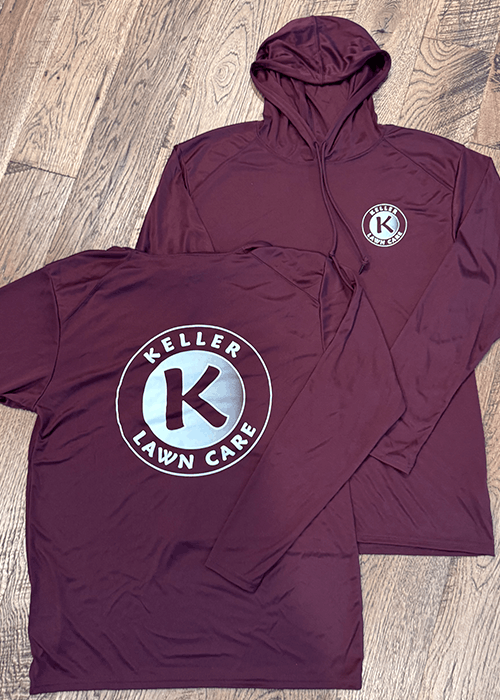 Two maroon long-sleeve shirts on wood floor, one hoodie and one crew neck, both with Keller Lawn Care logo featuring a large K inside a circle.