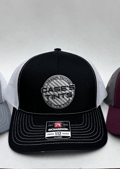 Black and white Richardson 112 trucker hat with a round patch reading 'Case's Tints Window Tinting' on the front.