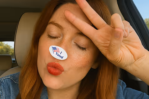 A young lady with an I Voted sticker on her nose