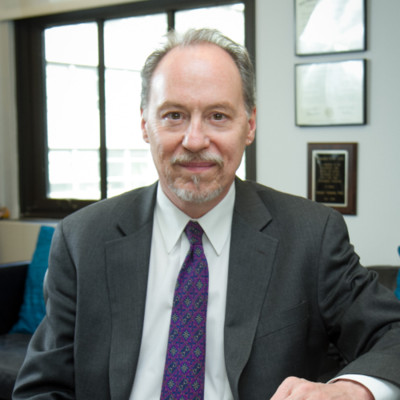 image of Dr. Andrew Tatarsky sitting in a suit