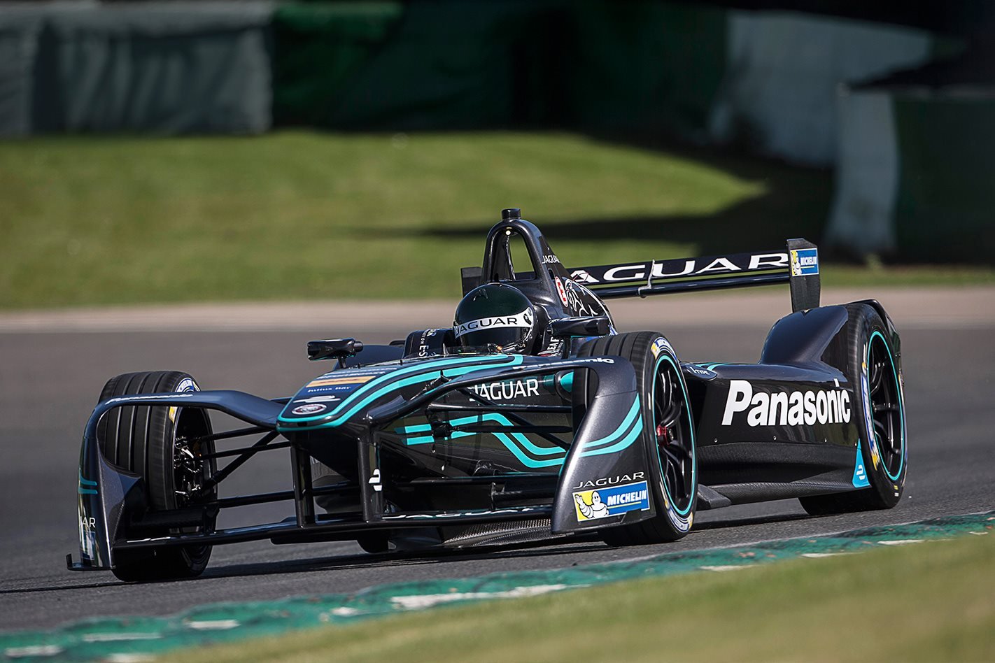 Jaguar Panasonic Formula E race car on a race track corner.