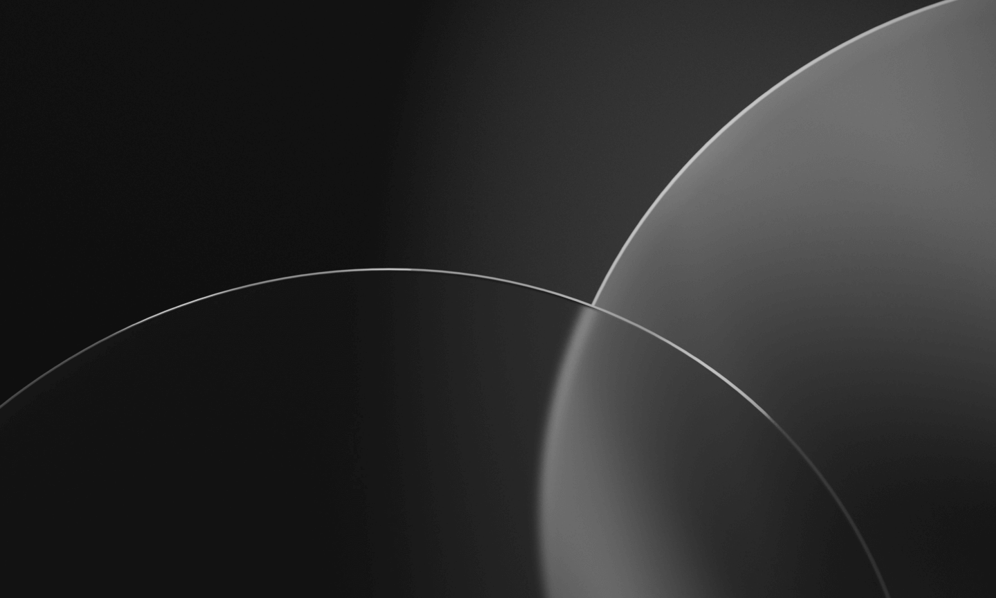 Abstract grayscale image featuring two overlapping translucent circles with soft gradient shading on a dark background.