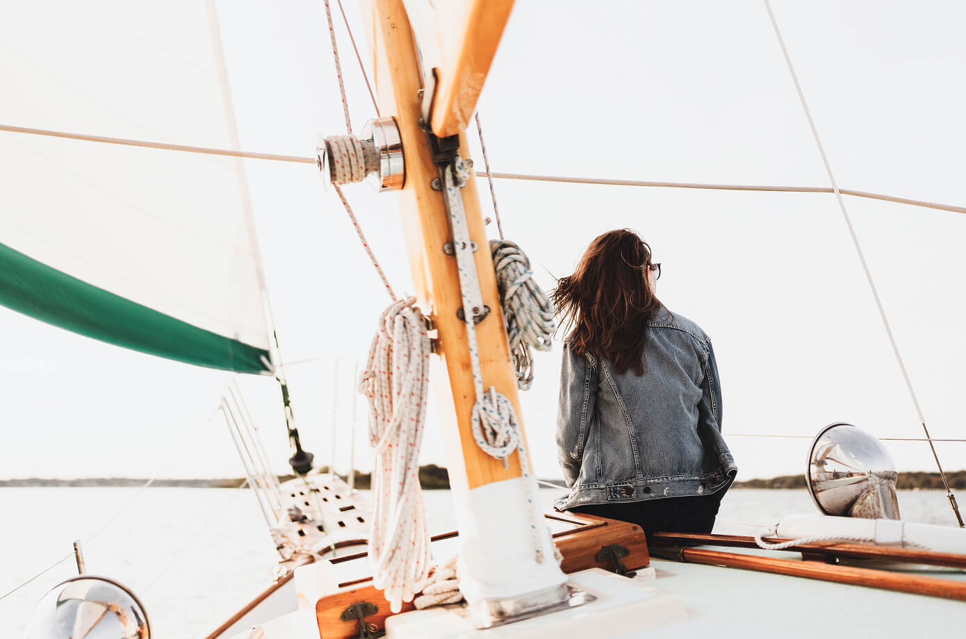 Woman sailing on open water, representing clarity and confidence in financial planning goals.