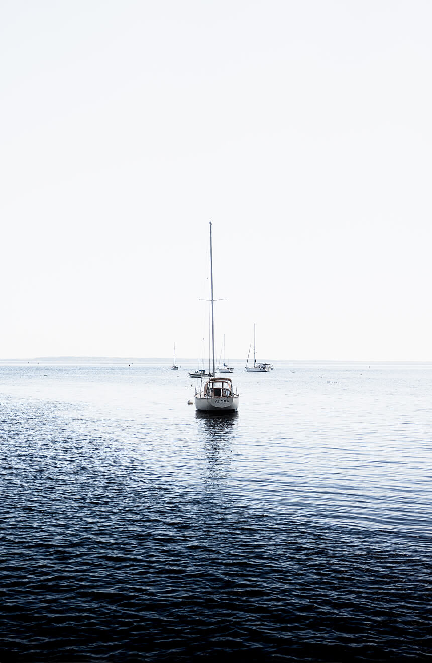 Sailboat on calm ocean waters, symbolizing long-term financial planning, direction, and stability.