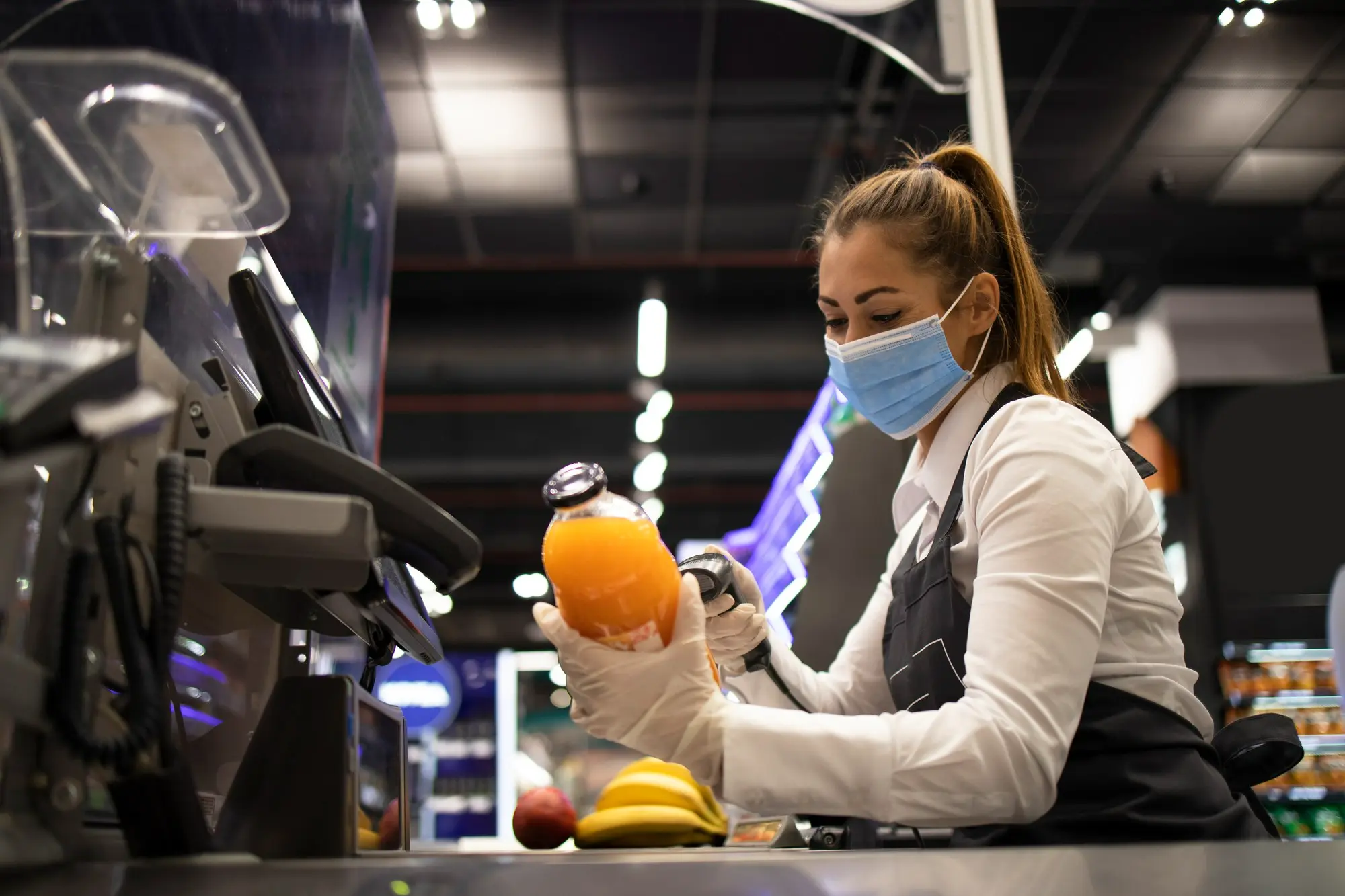 Woman working as a grocery store cashier, representing employment while attending intensive outpatient rehab