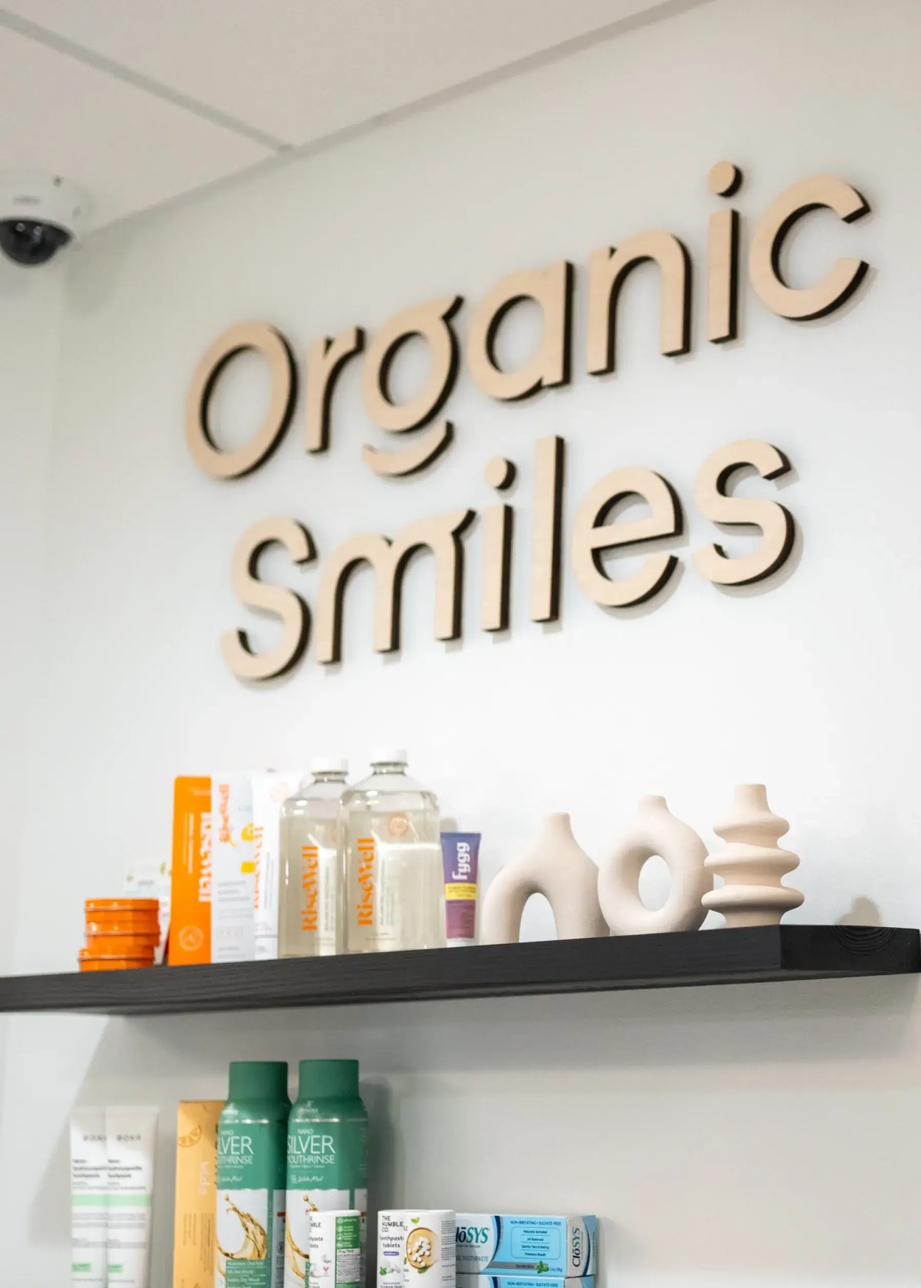 Shelf with dental care products below a sign reading "Organic Smiles."
