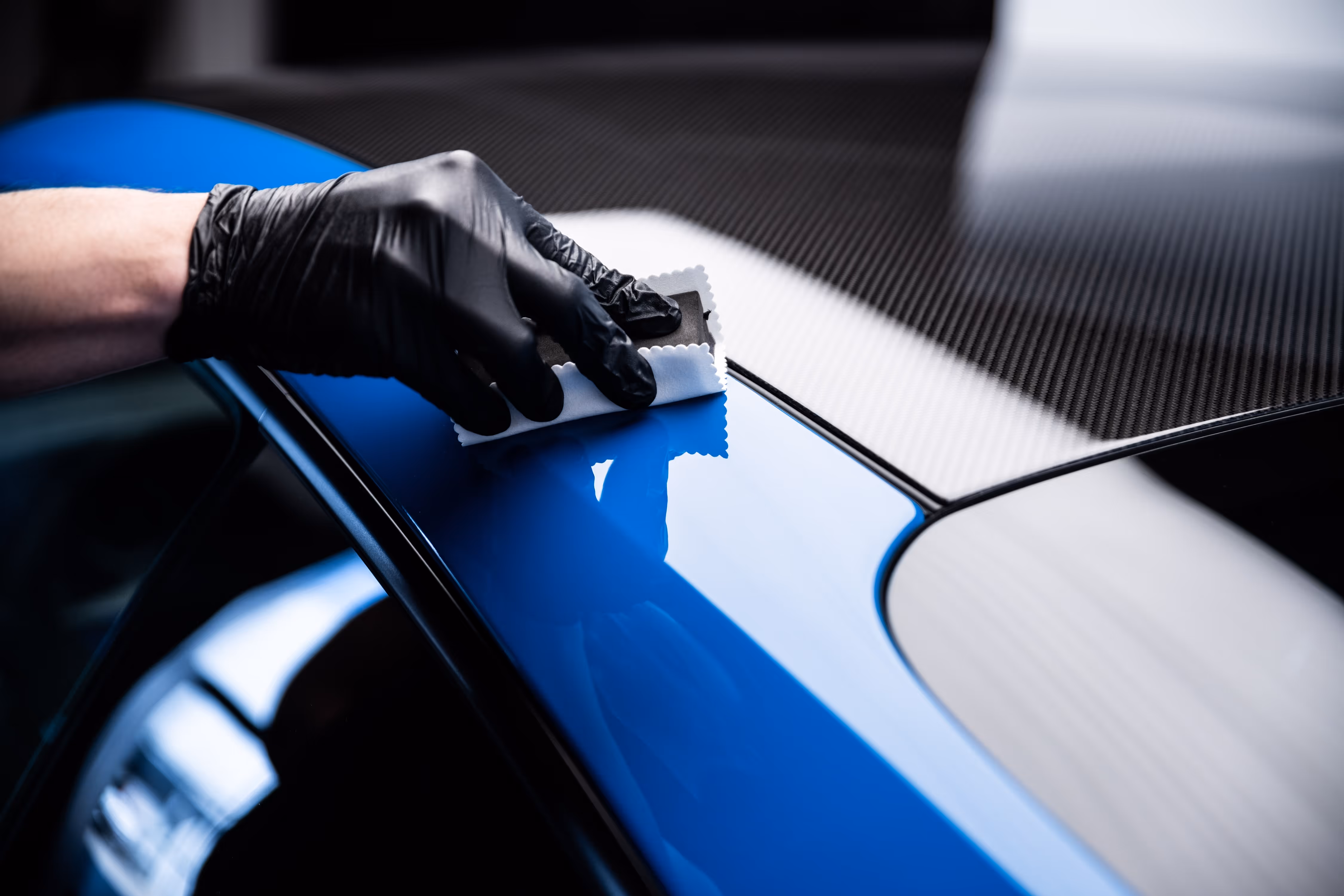 Certified Feynlab ceramic coating being applied to car hood for gloss, self-healing protection, and hydrophobic finish.