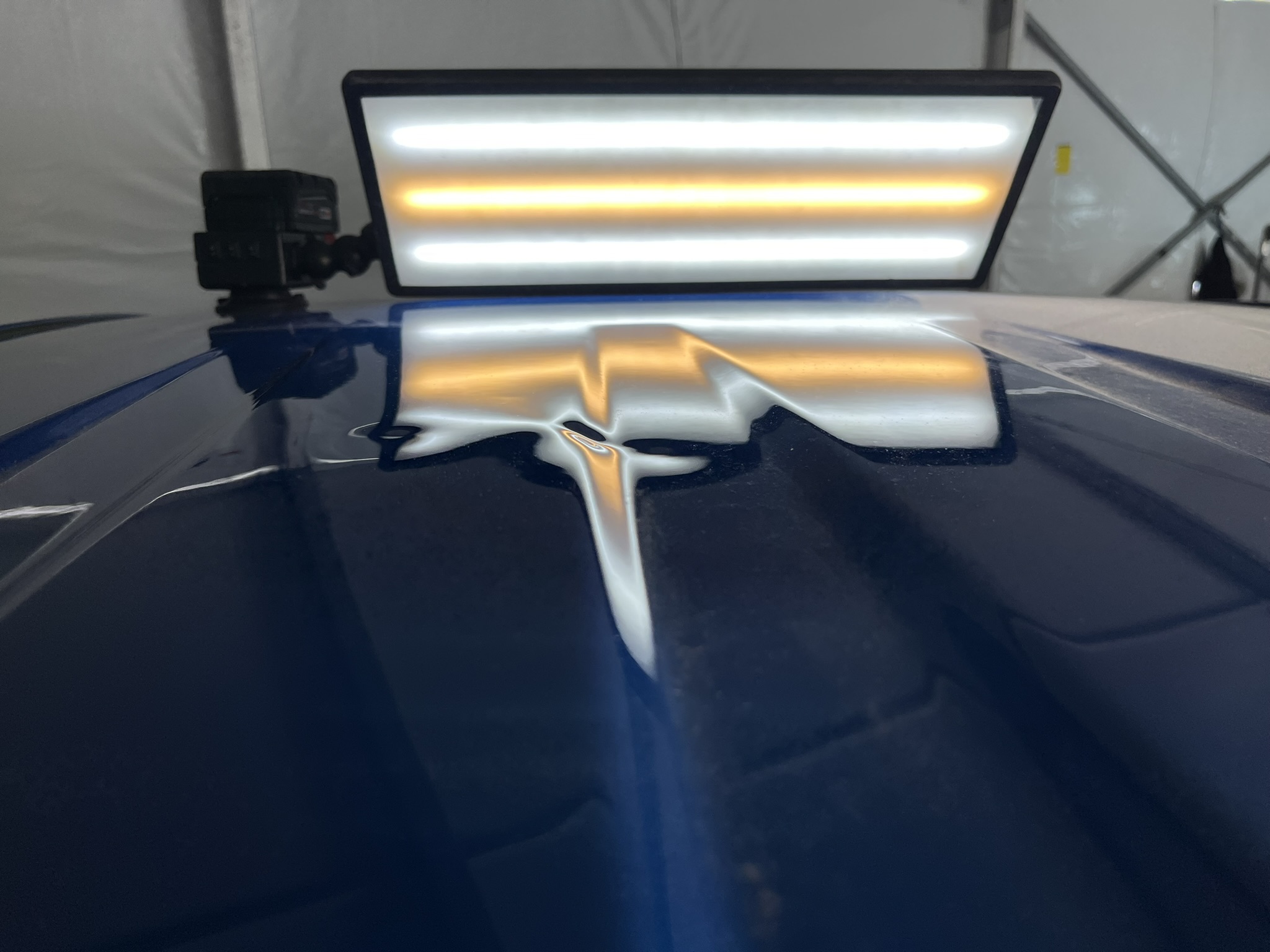 Blue Chevrolet Colorado roof with hail damage before paintless dent repair at KOD Auto Films