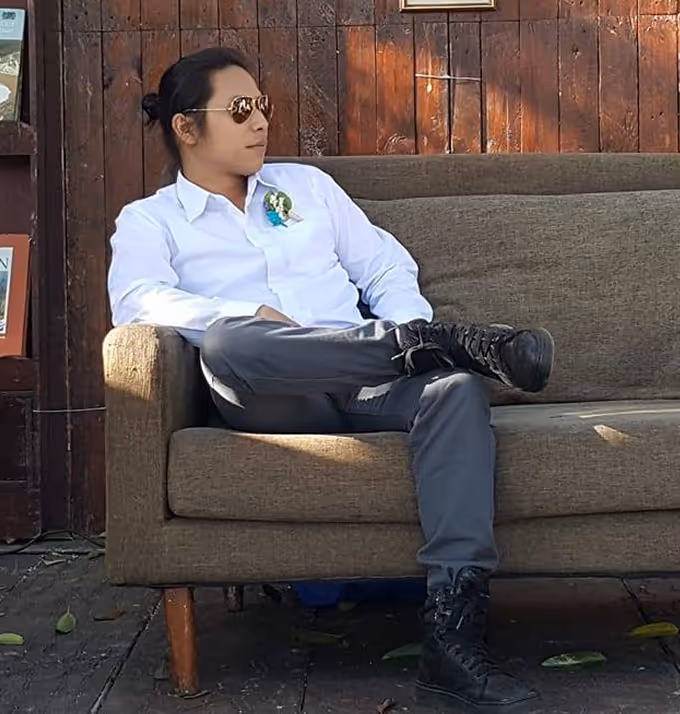 A picture of James sitting on a couch