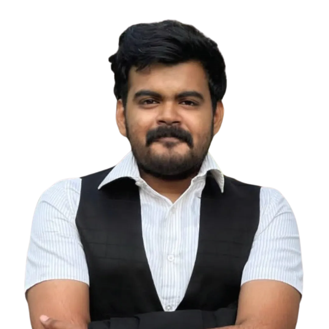 Man with dark hair and beard wearing a white striped shirt and black vest with arms crossed.
