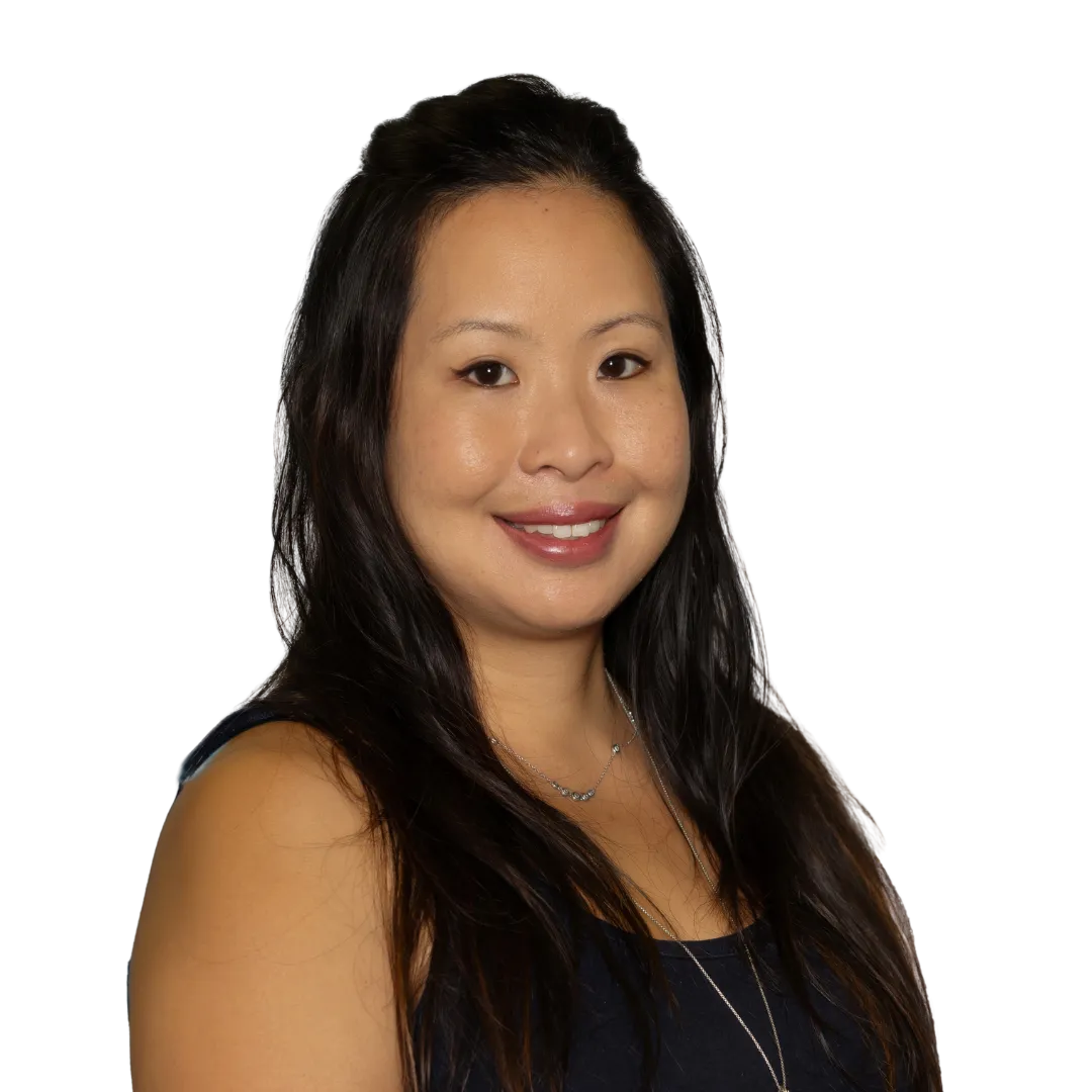Smiling woman with long dark hair wearing a dark sleeveless top and a silver necklace.
