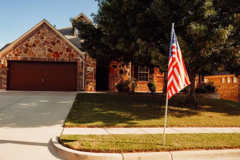lawn in front of a brick and stone house