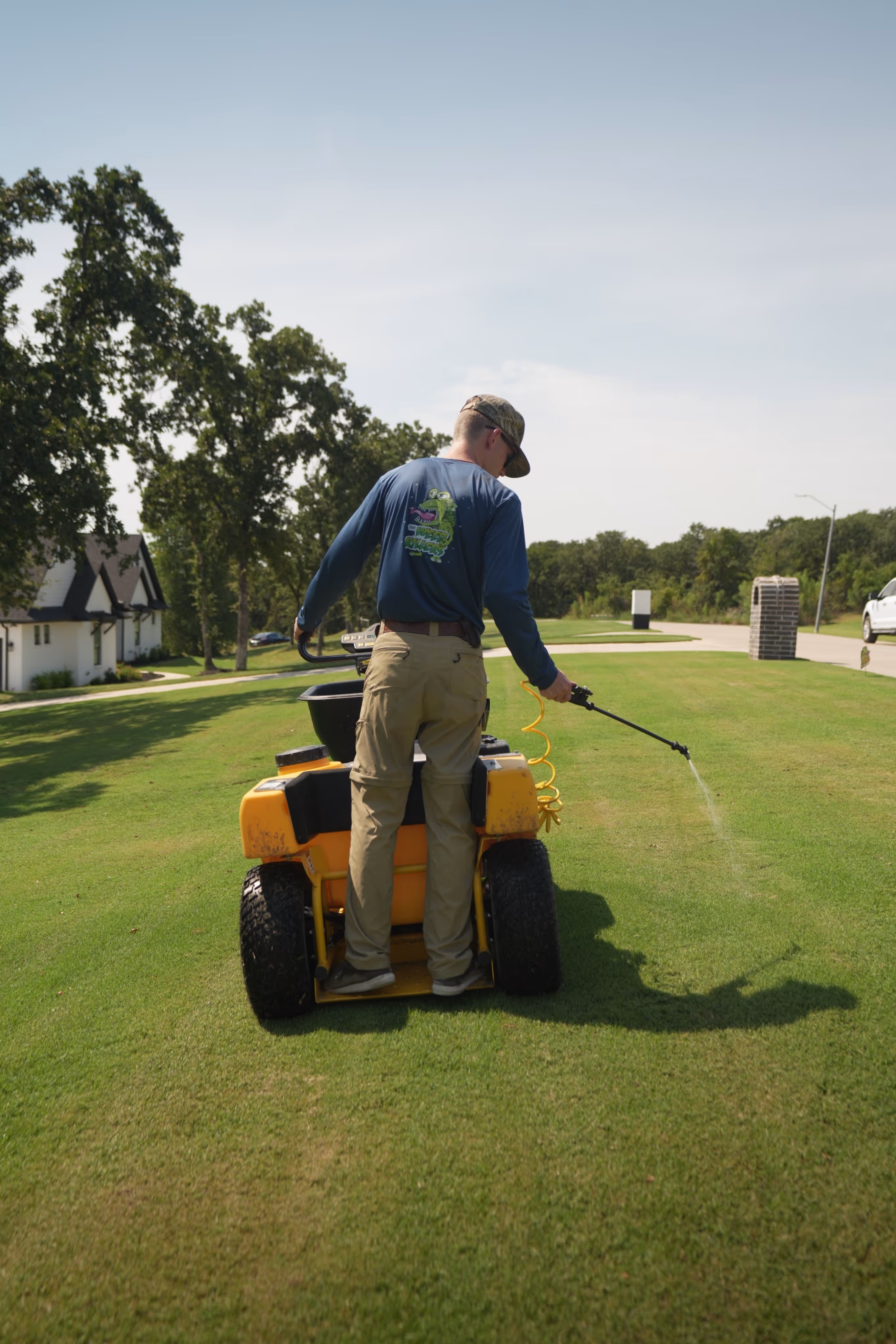 lawn spreader to spray fertilizer or pesticide on a green lawn