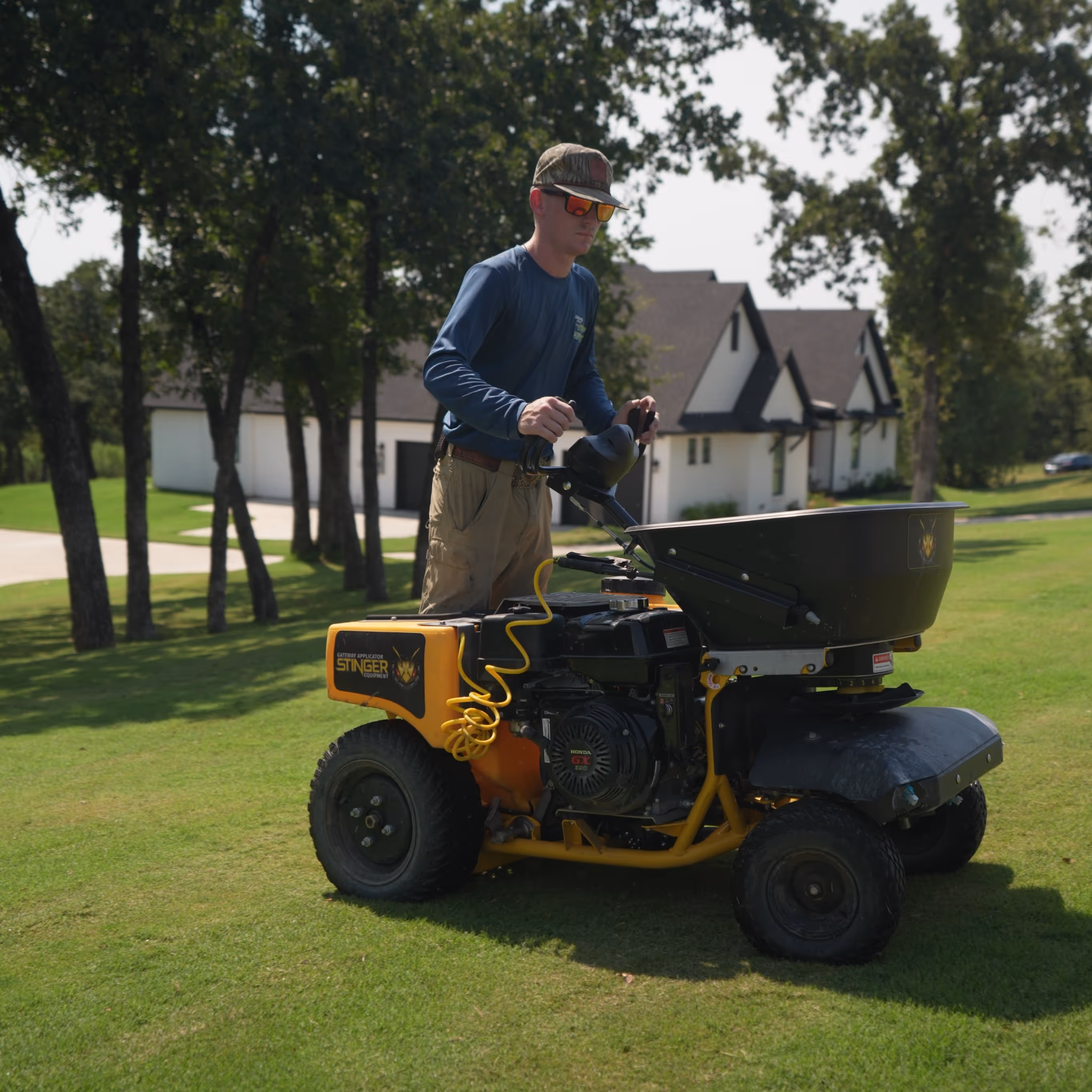  Stinger lawn equipment on grass near houses and trees.