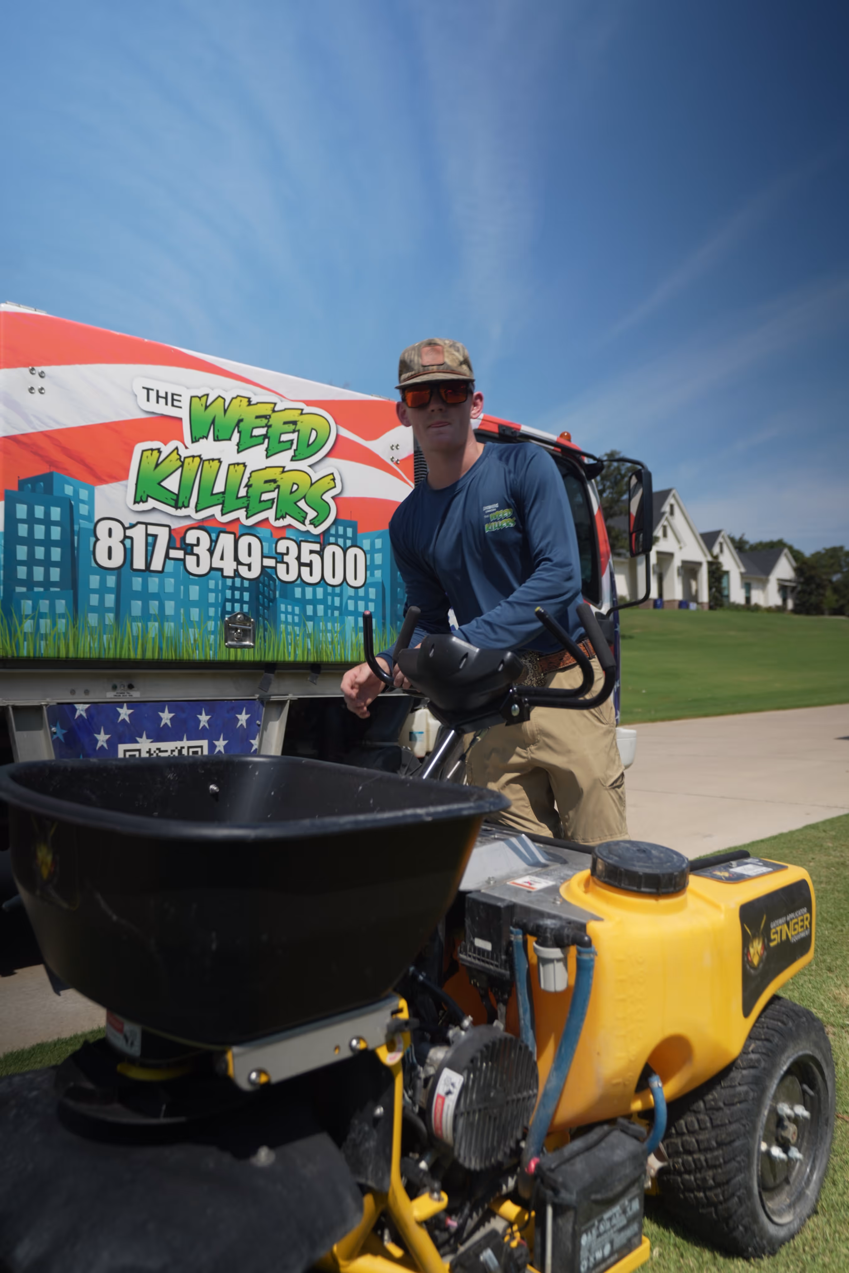 Stinger lawn equipment with a Weed Killers truck in the background.