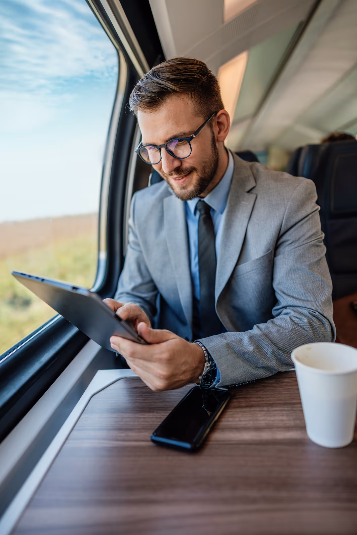 man scrolling through his tablet