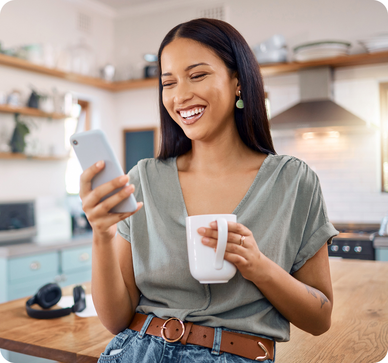 woman on phone holding a cup of coffee