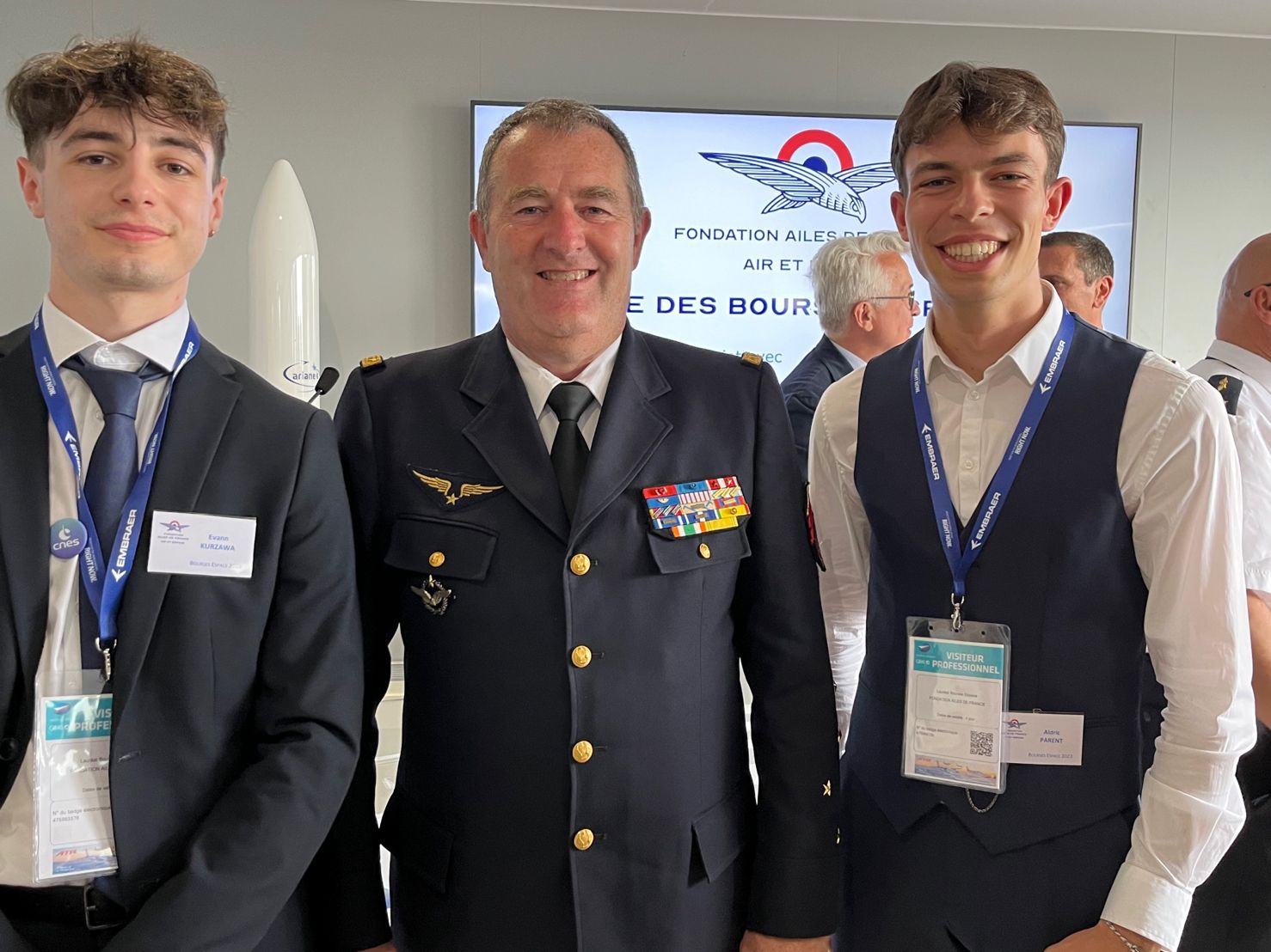 image of engineers working on satellite components [team]