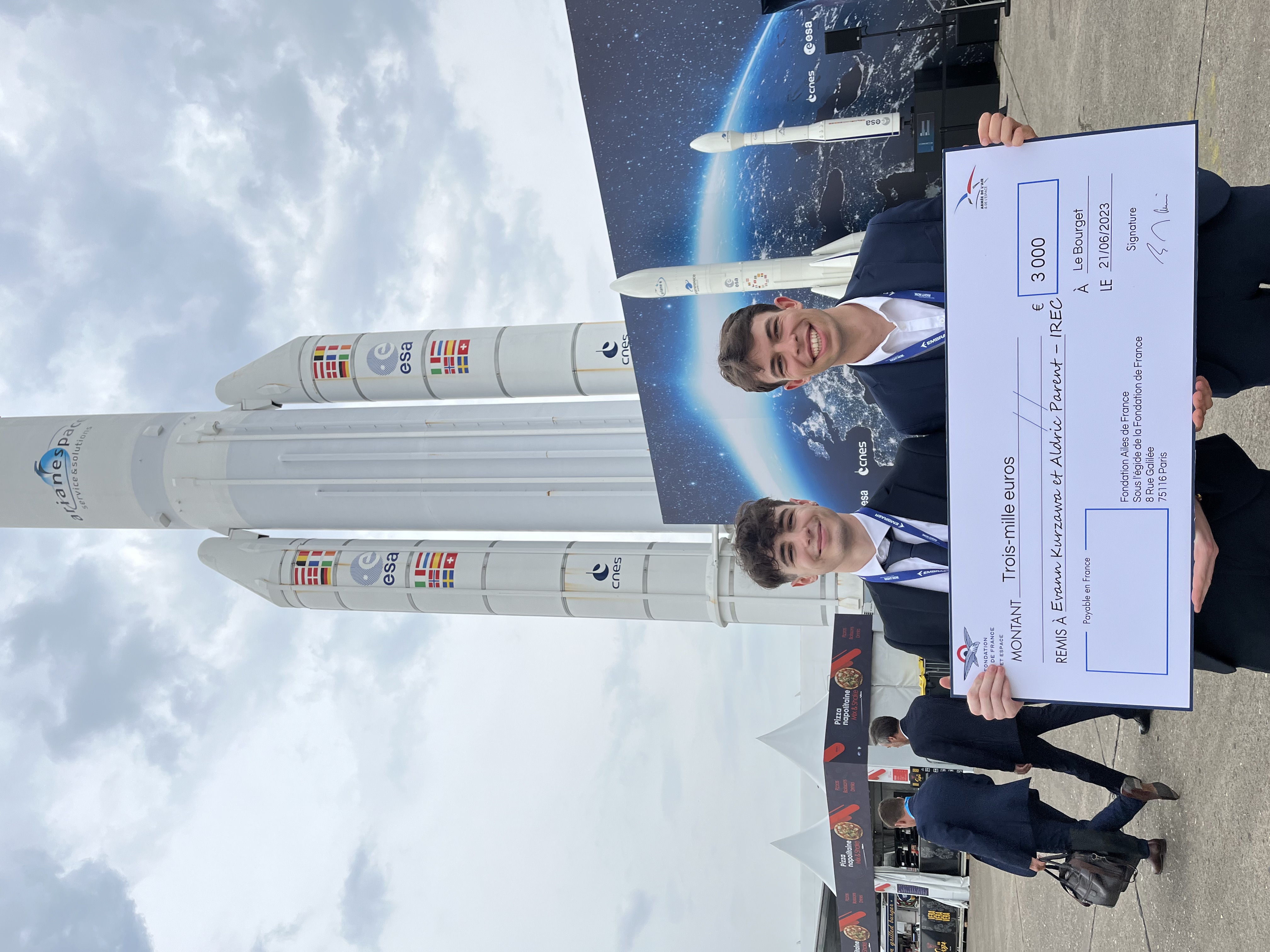 image of engineers working on satellite components [team]