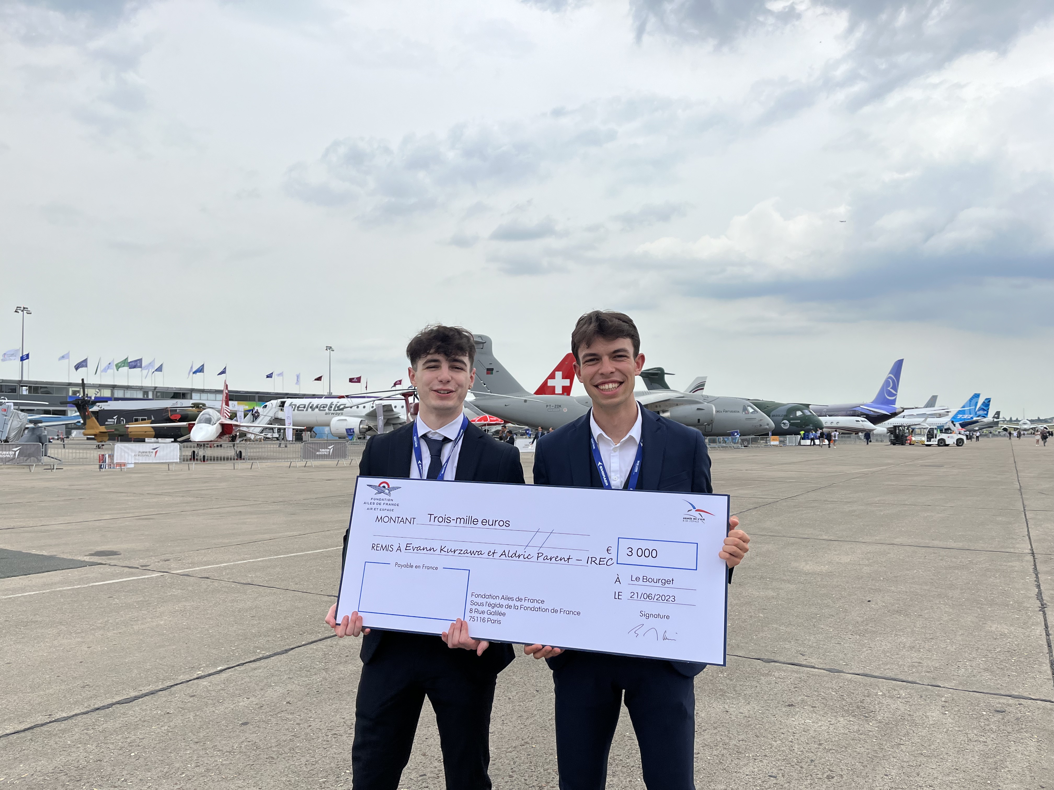 image of engineers working on satellite components [team]