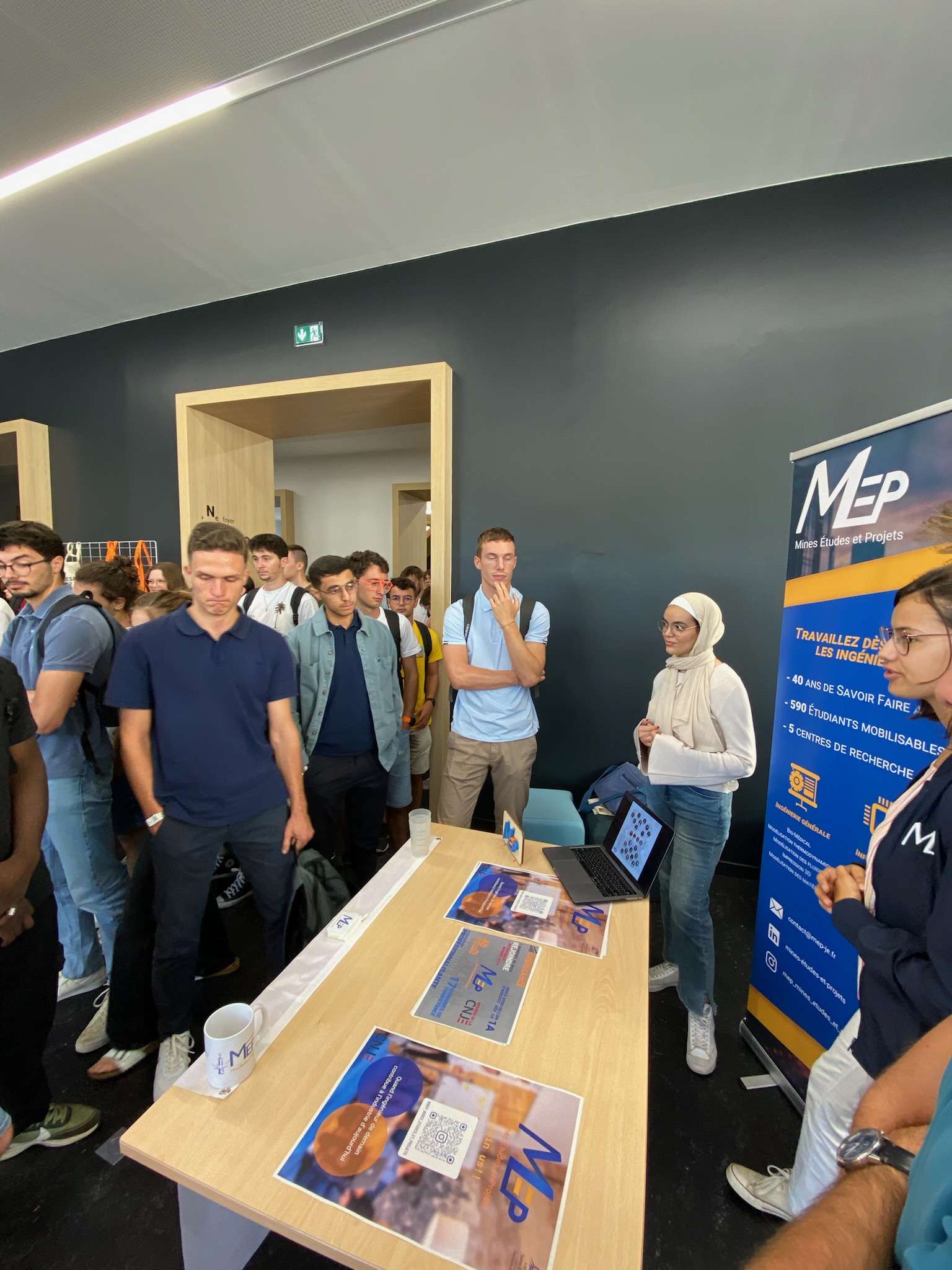 image of engineers working on satellite components [team]