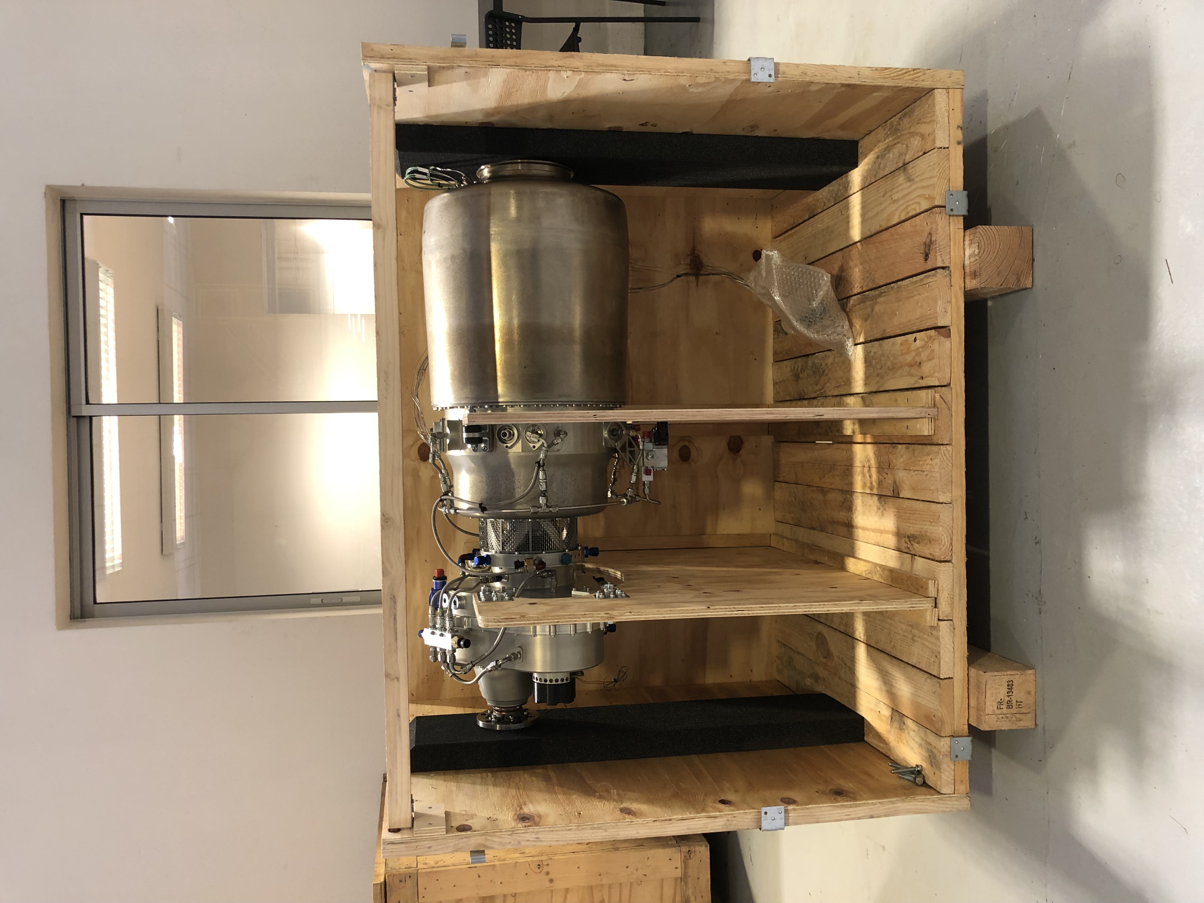 image of engineers working on satellite components [team]