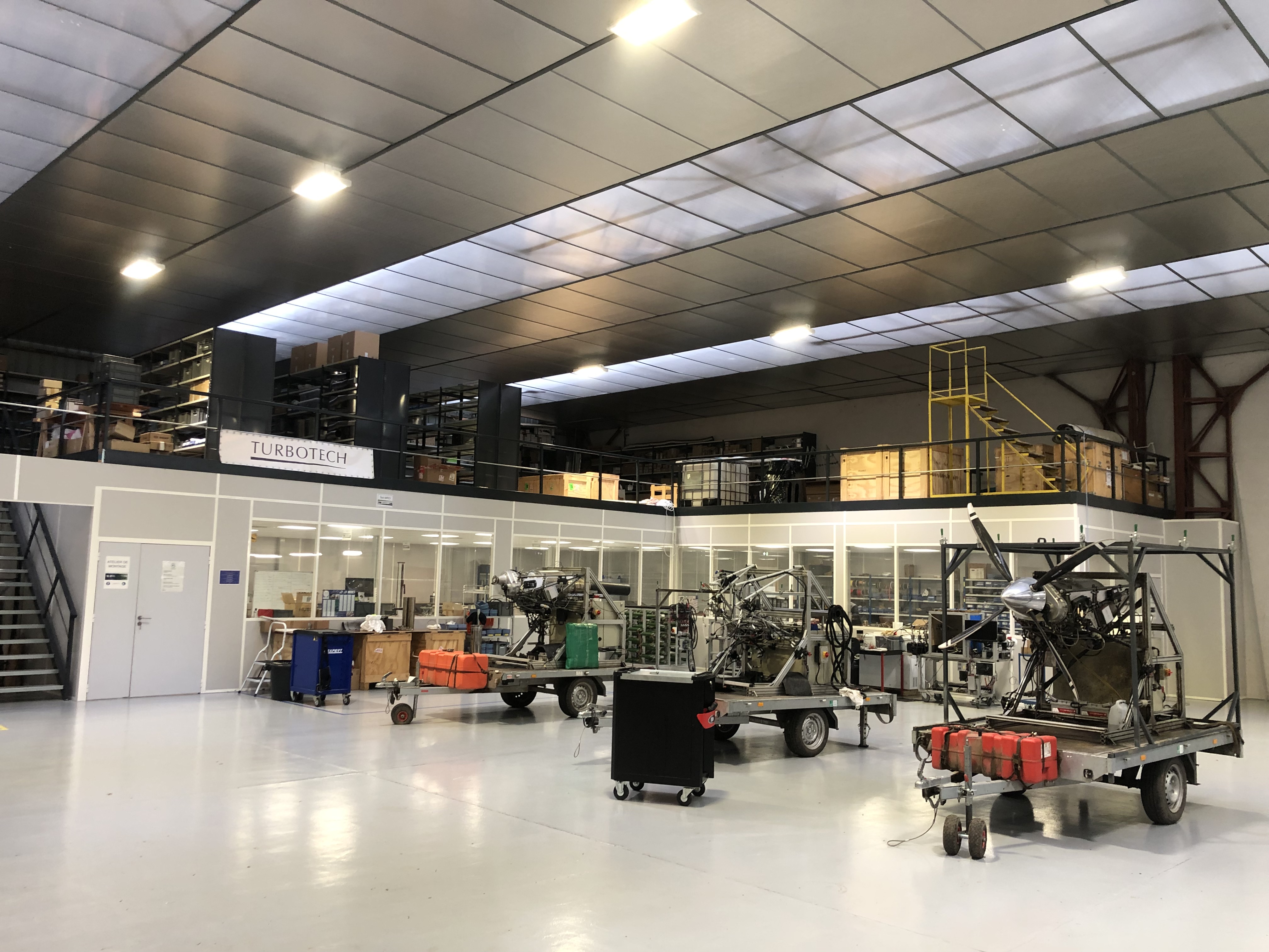 image of engineers working on satellite components [team]