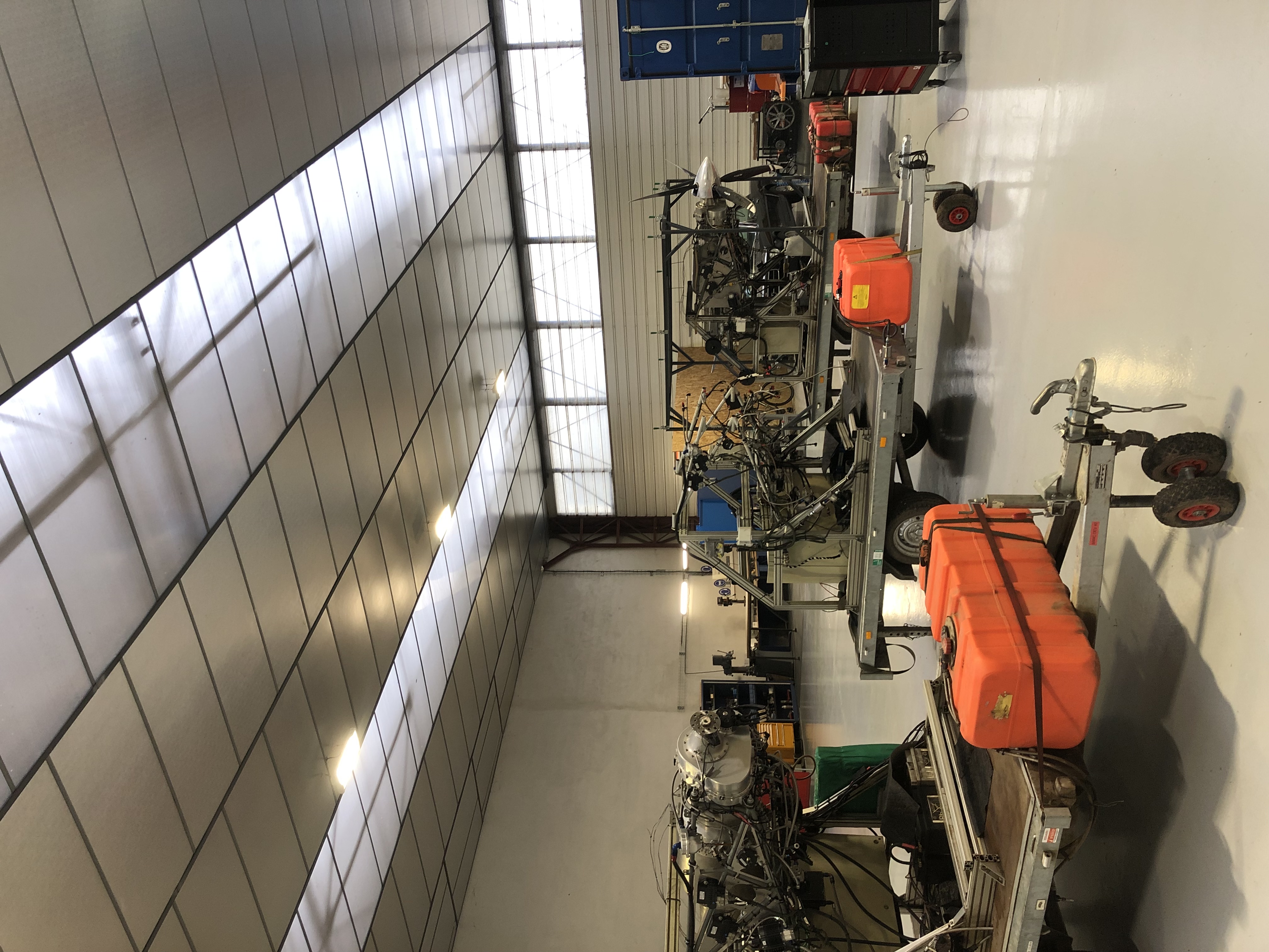 image of engineers working on satellite components [team]