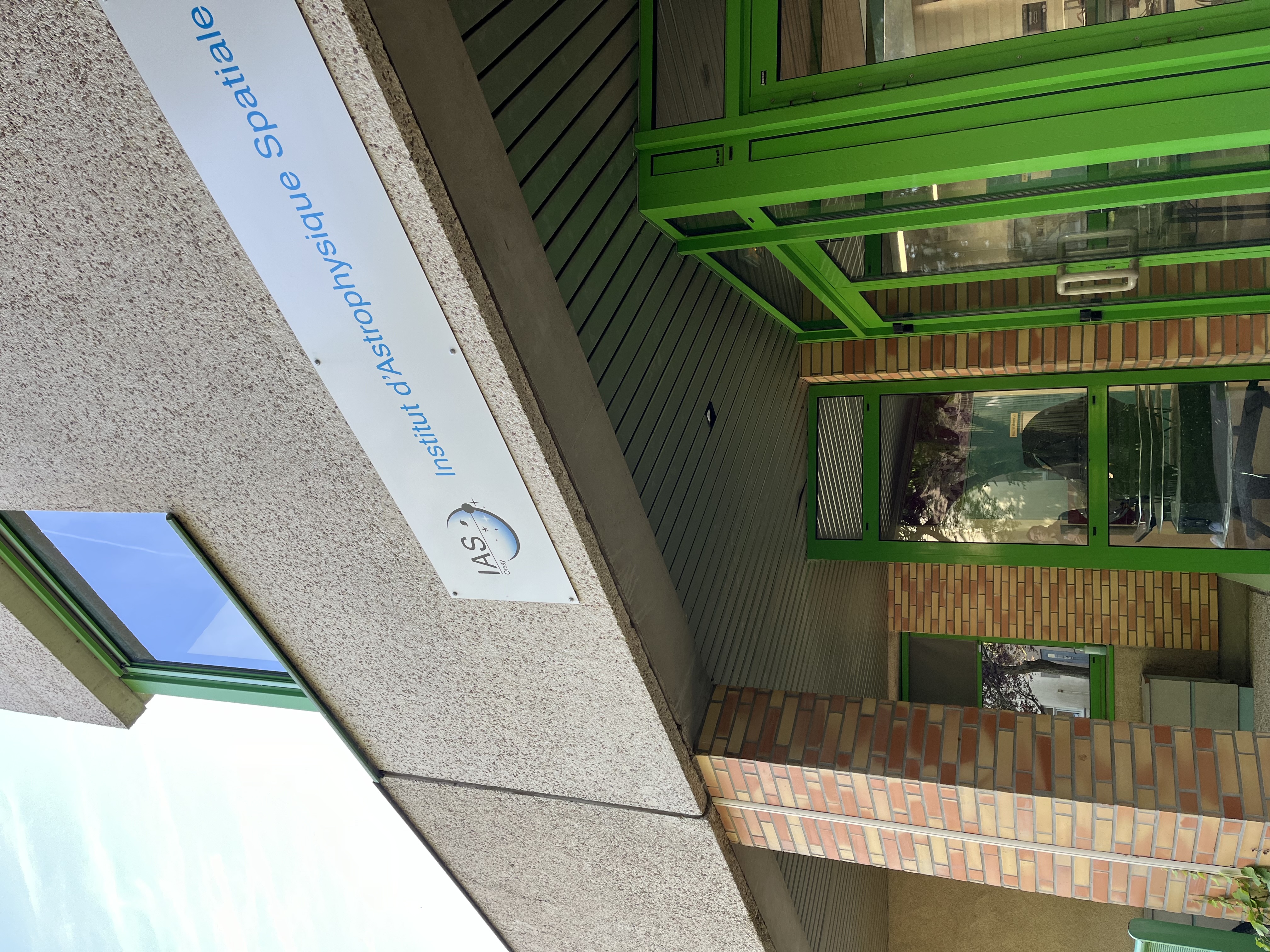 image of engineers working on satellite components [team]