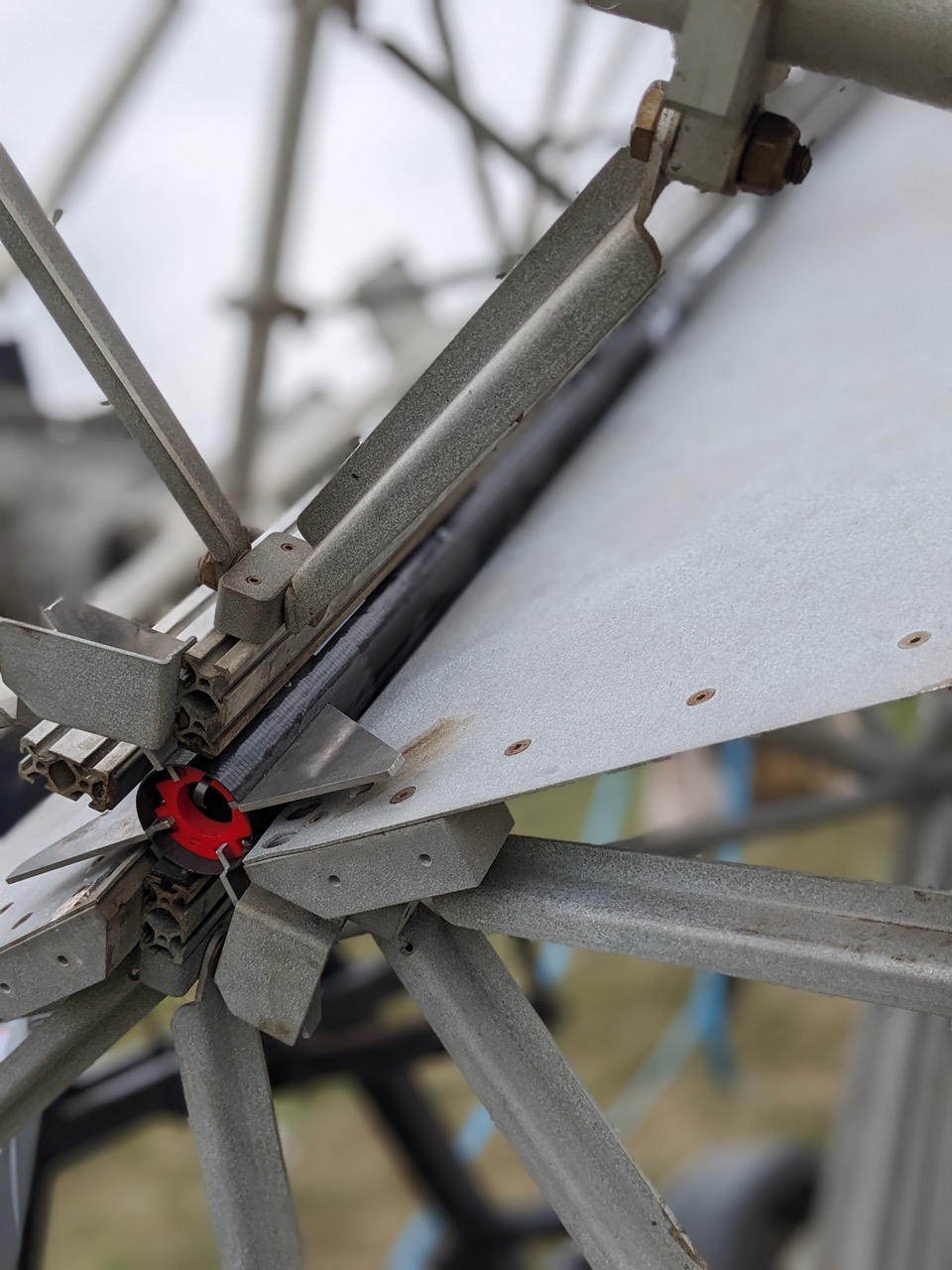 image of engineers working on satellite components [team]