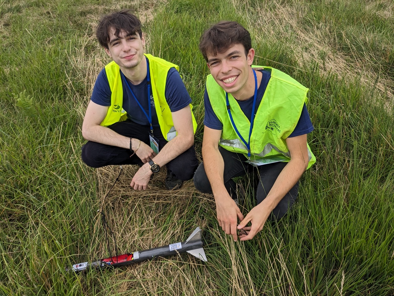 image of engineers working on satellite components [team]
