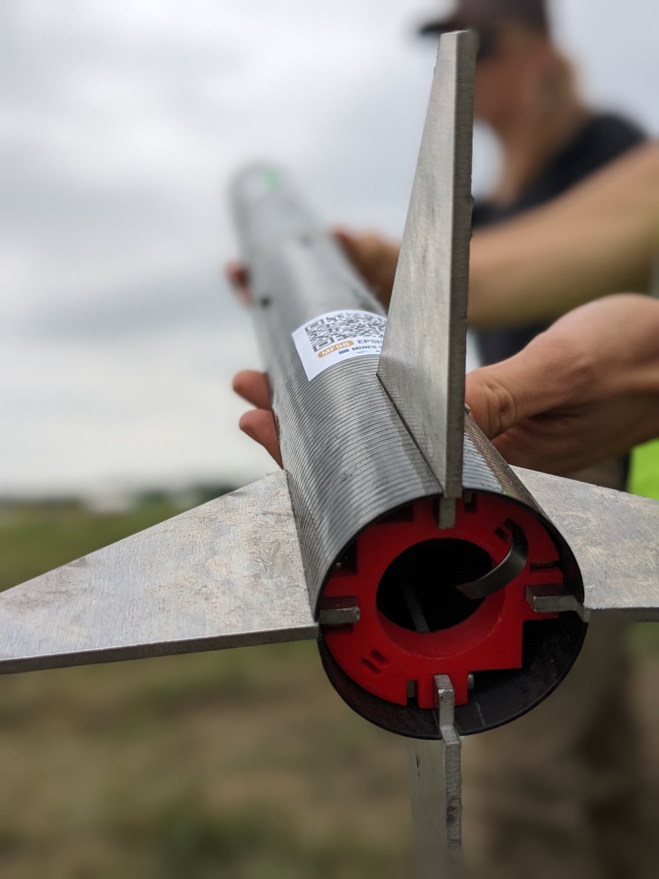 image of engineers working on satellite components [team]