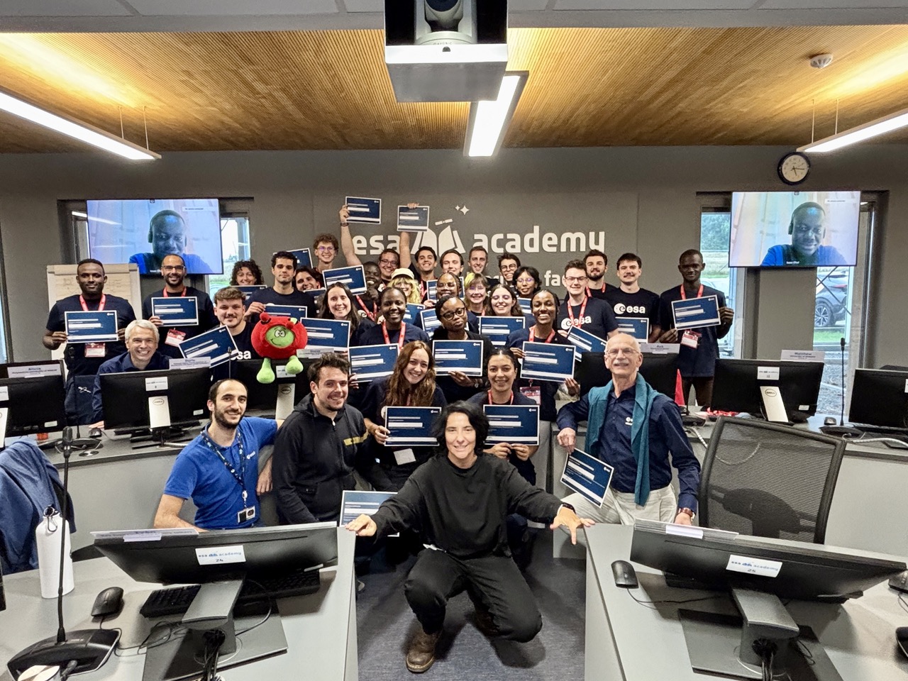 image of engineers working on satellite components [team]