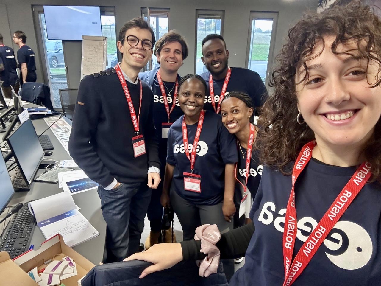 image of engineers working on satellite components [team]